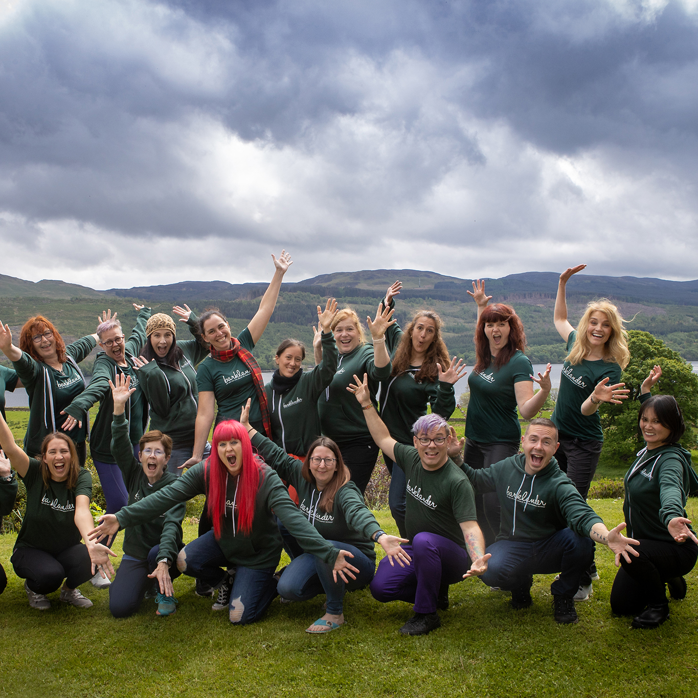 Group of people wearing green celebrating in the Scottish Highlands