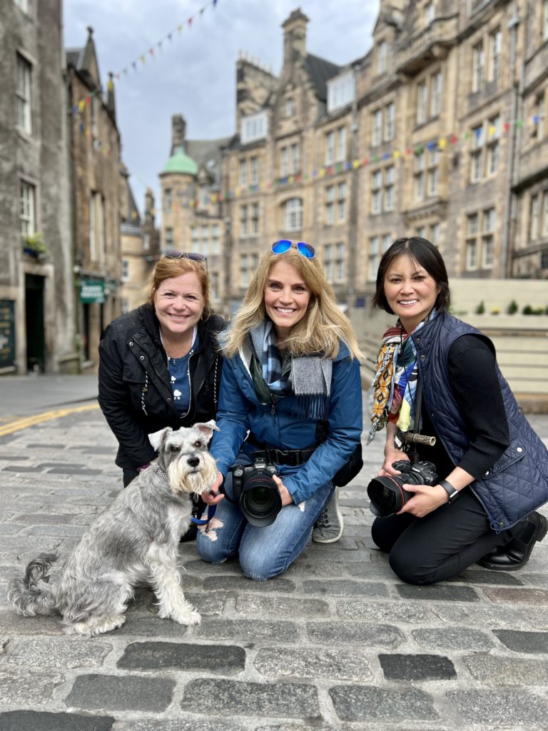 three women with a gray dog