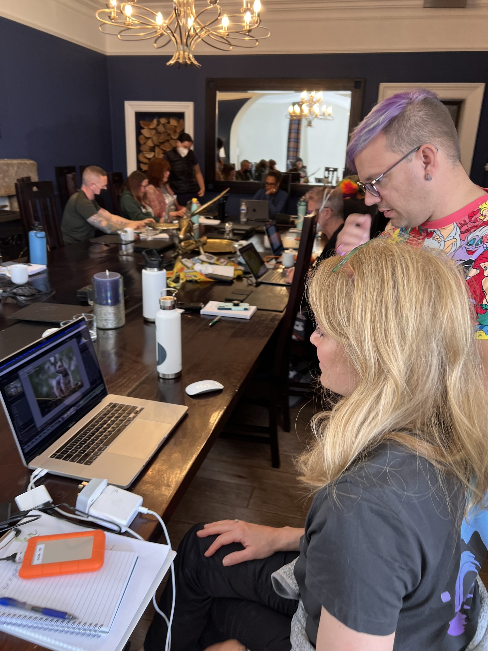 woman with a laptop while a man looks over her shoulder