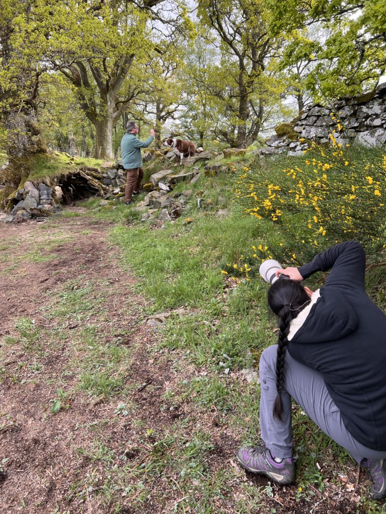 woman photographer taking pictures of a man and dog