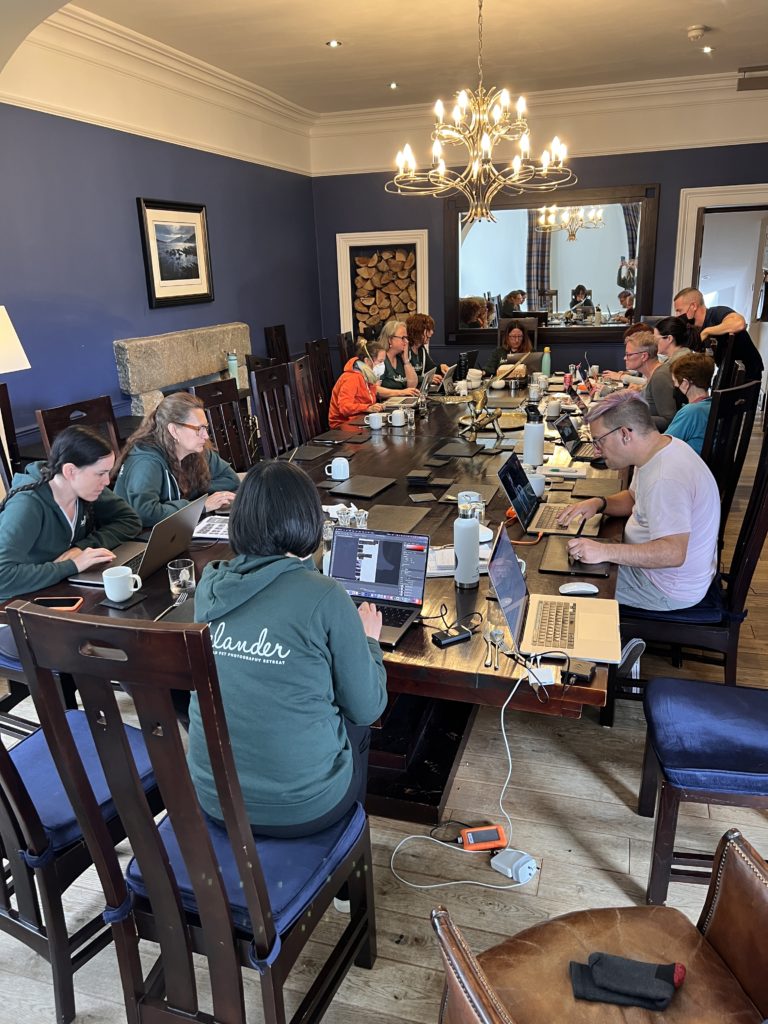 a group of people with laptops at a table