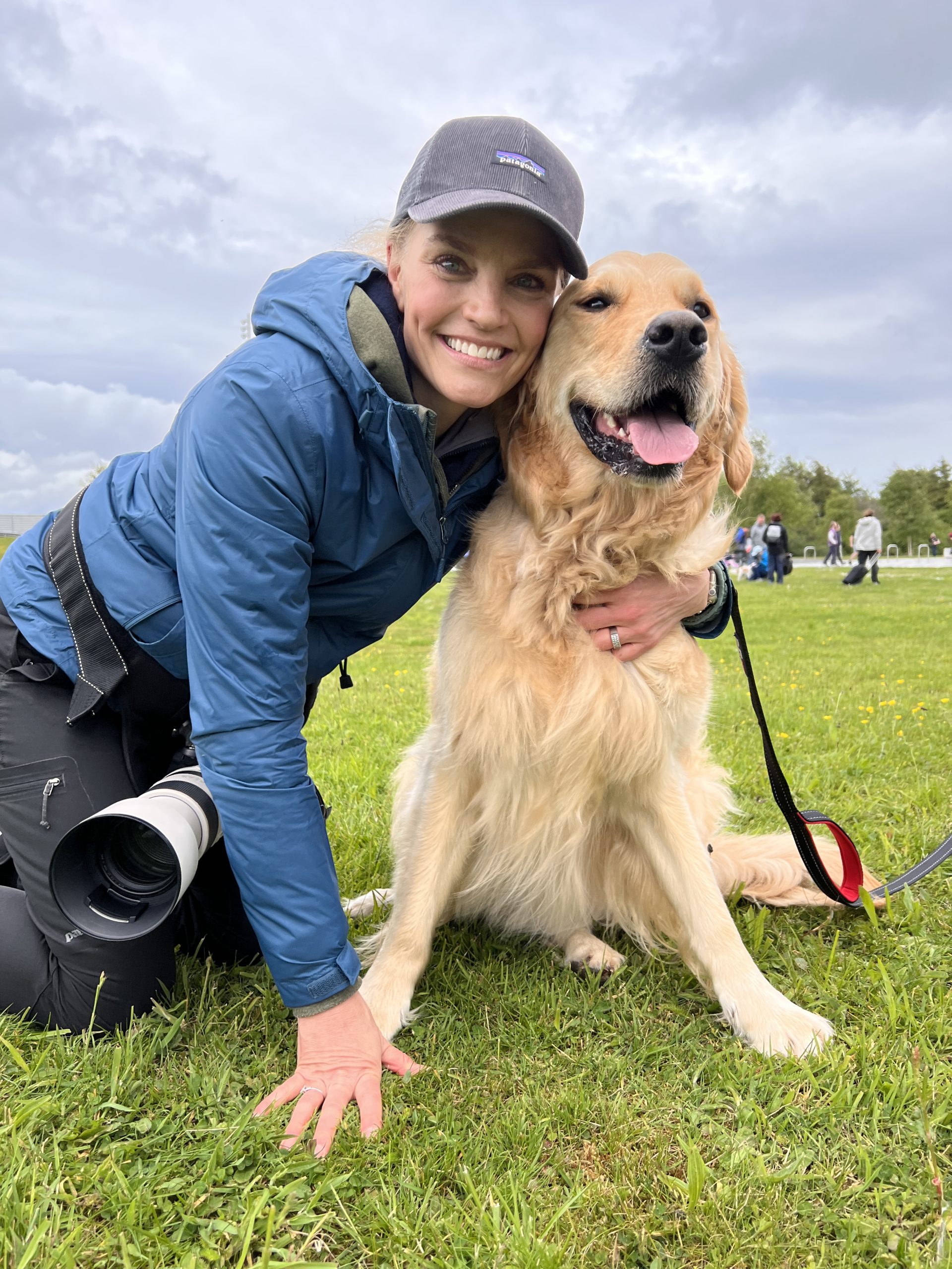 woman hugging a golden retriever