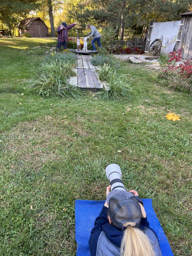 woman photographer taking pictures of dog