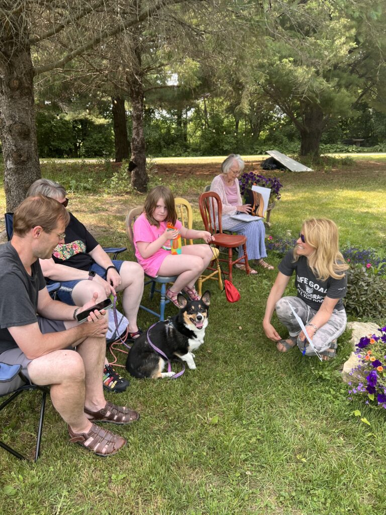 a group of people and a dog talking outside